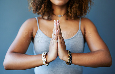 Buy stock photo Cropped shot of a young woman practising yoga by herself