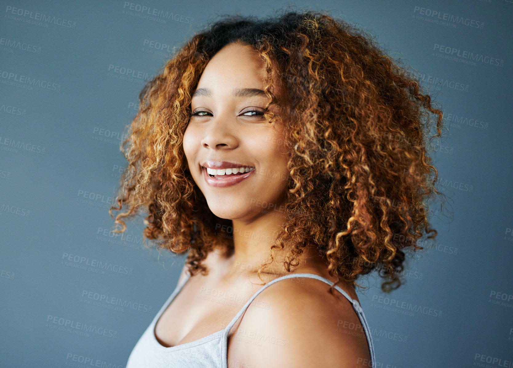Buy stock photo Confidence, black woman or portrait for smile, hair care or natural beauty for skincare and cosmetics. Gray background, face and proud model in studio with curly results and healthy glow in Brazil