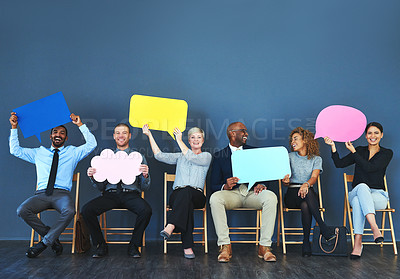 Buy stock photo Shot of a group of people holding up speech bubbles against a blue background