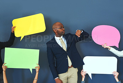 Buy stock photo Cropped shot of people holding up speech bubble around a young man
