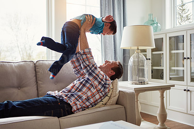 Buy stock photo Dad, child and happy on sofa for airplane game, playful and bonding with care, love and laughing in house. Father, boy and lifting for plane, connection and flight on couch in lounge at family home