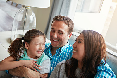 Buy stock photo Relax, kid and happy family in home with parents together for care, love or bonding. Child, mother and father on sofa for support, conversation and playing with funny girl laughing in living room