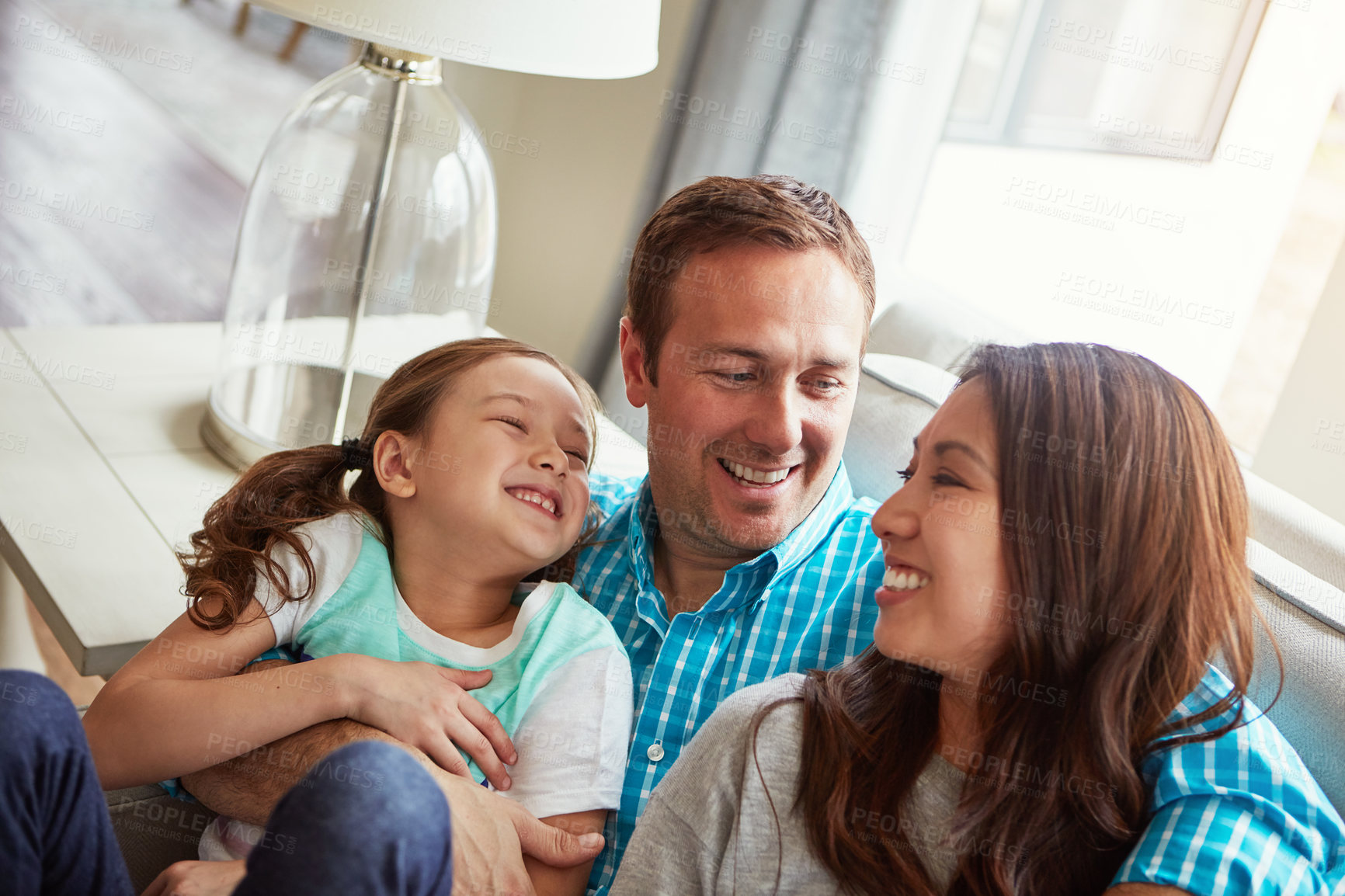 Buy stock photo Love, kid and happy family in home with parents together for care, relax and bonding. Child, mother and father on sofa for support, conversation and healthy relationship with girl in living room