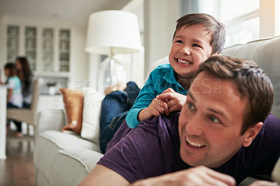 Buy stock photo Playing, happy and dad with child on sofa for bonding, laughing and relax together on weekend. Family, morning and father with young boy on couch for playful relationship, love and fun in living room