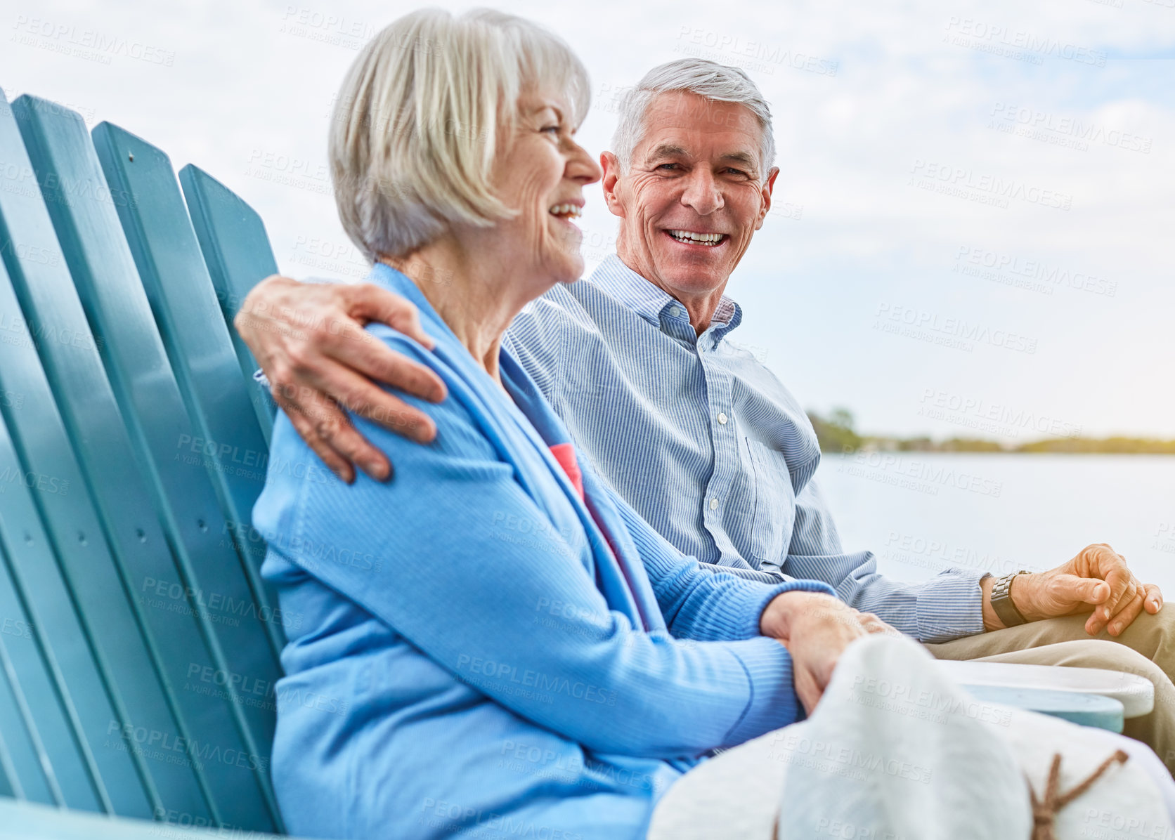 Buy stock photo Portrait of an affectionate senior couple relaxing on chairs together outside