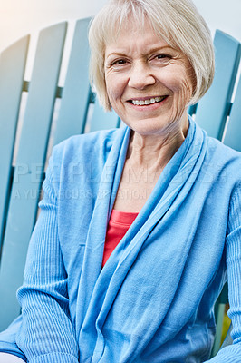 Buy stock photo Portrait of a happy senior woman relaxing on a chair outside