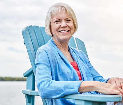 Buy stock photo Portrait of a happy senior woman relaxing on a chair outside