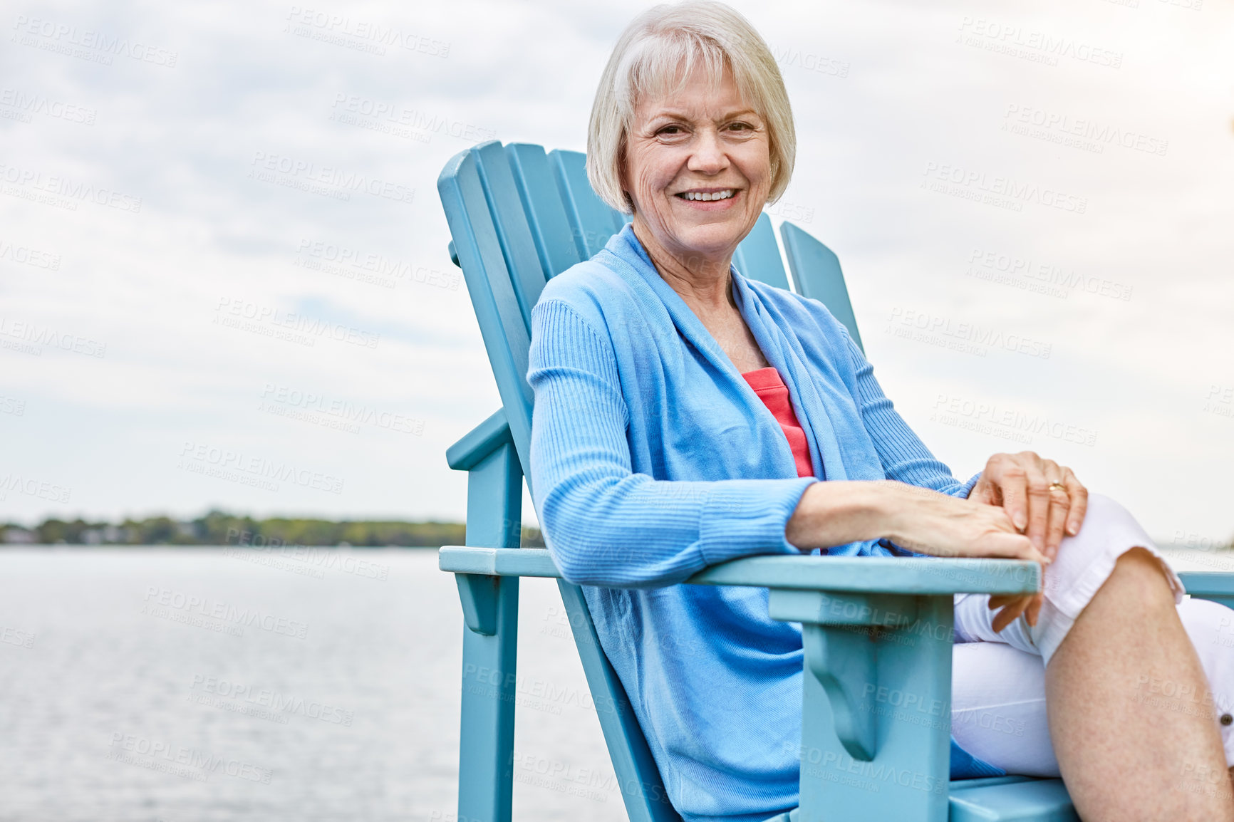 Buy stock photo Happy, portrait and travel with old woman at lake in nature for holiday, retirement or vacation. Break, chair and space with smile of senior person outdoor for me time chilling, pause or unwind