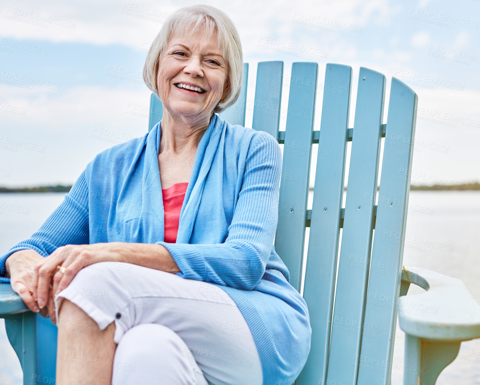 Buy stock photo Portrait of a happy senior woman relaxing on a chair outside