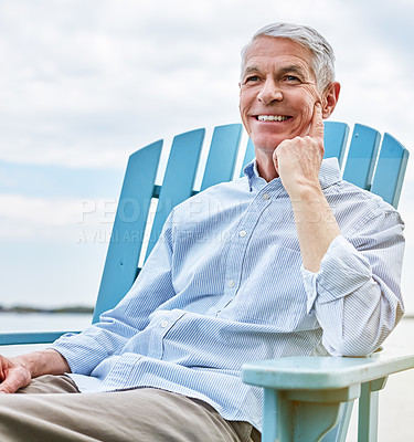 Buy stock photo Shot of a happy senior man relaxing on a chair outside