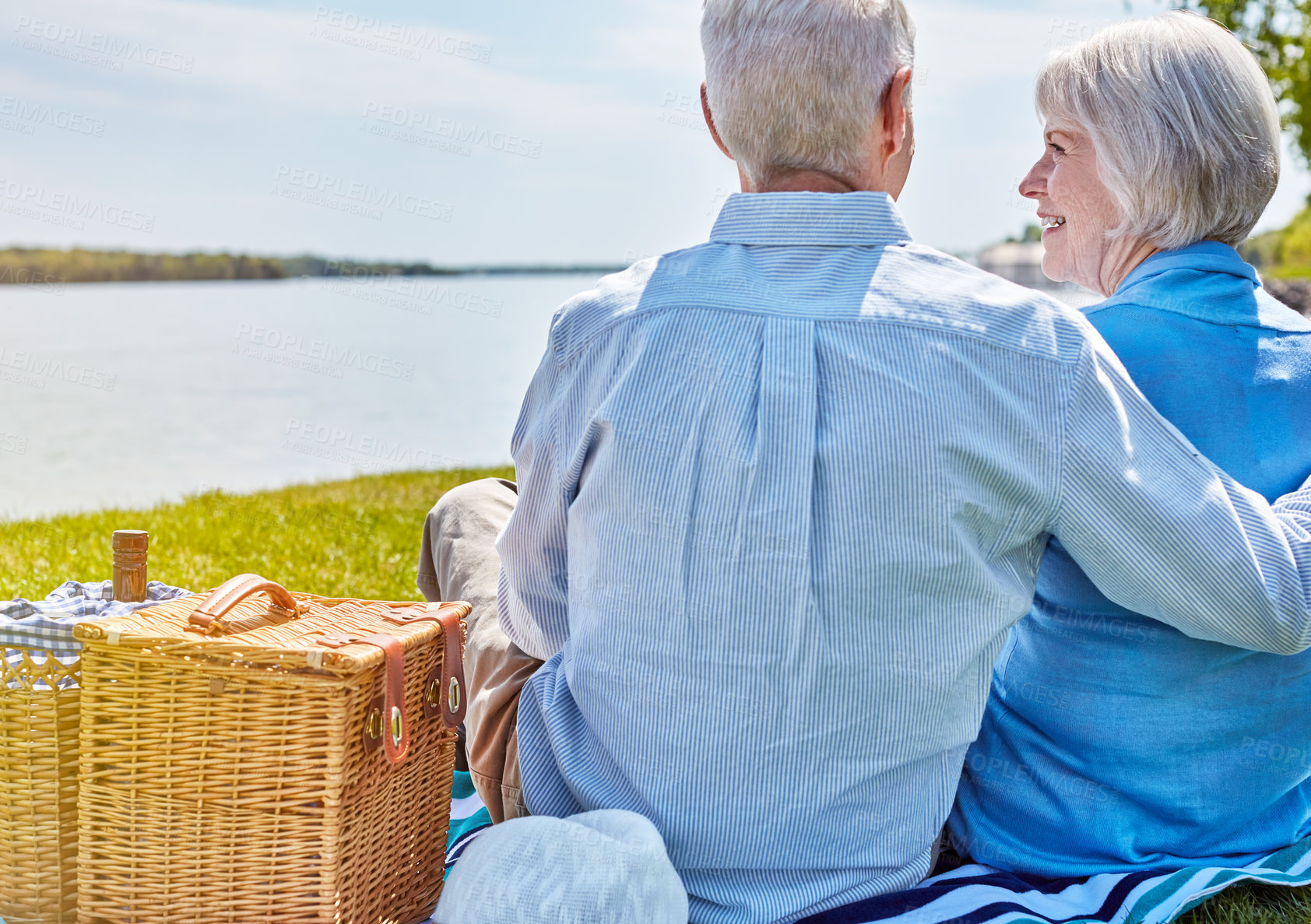 Buy stock photo Shot of a happy senior couple having a picnic together outside