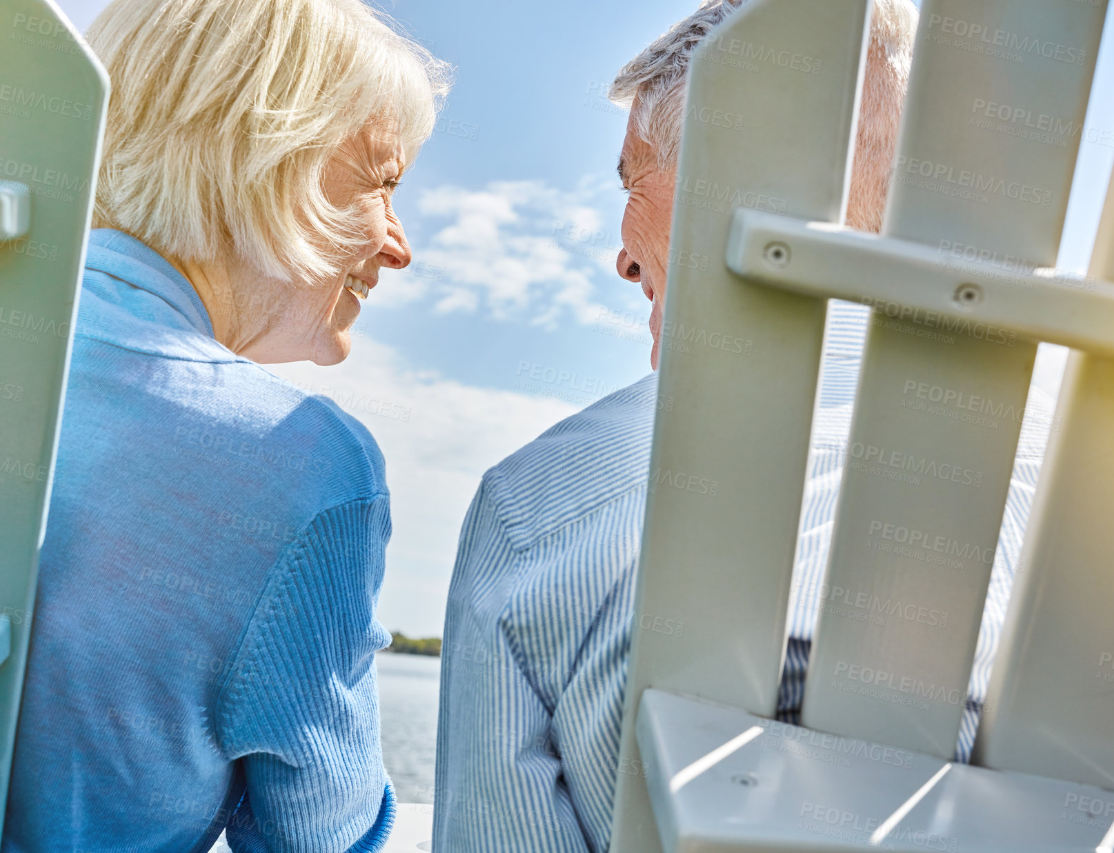 Buy stock photo Shot of an affectionate senior couple relaxing on chairs together outside