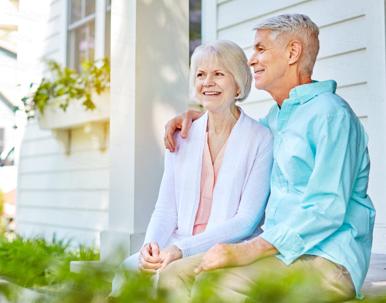 Buy stock photo Cropped shot of an affectionate senior couple sitting outside on their porch during the summer