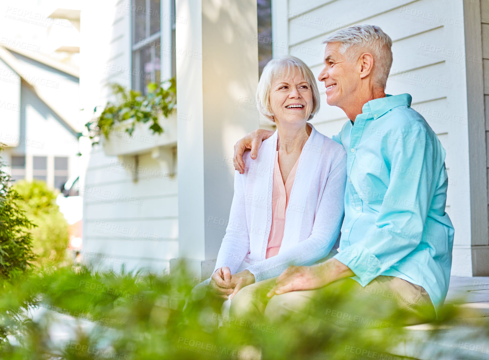 Buy stock photo Cropped shot of an affectionate senior couple sitting outside on their porch during the summer