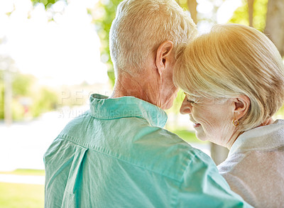 Buy stock photo Rearview shot of an affectionate senior couple standing outside during the summer