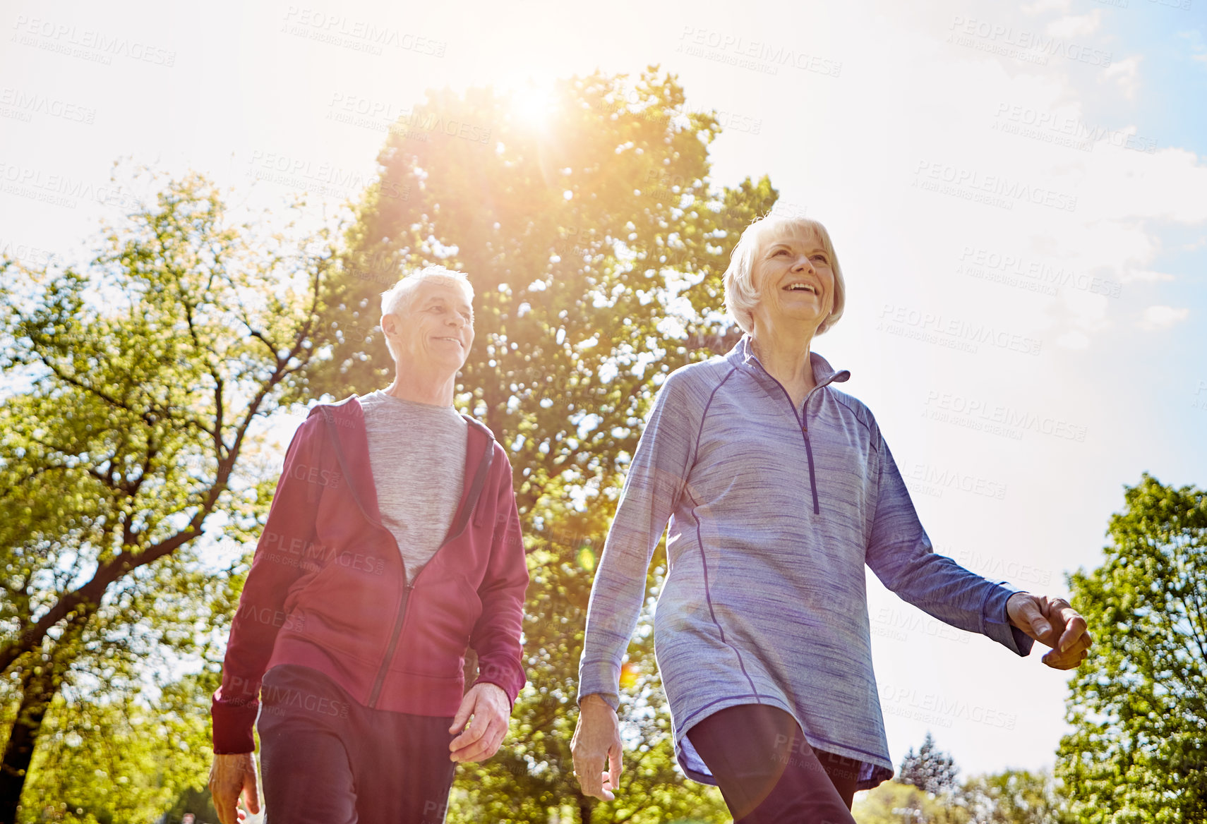 Buy stock photo Senior couple, retirement and walk in nature for fresh air, security and love in park. Elderly man, woman and together for life insurance with leisure, happiness or fitness outdoors in Australia