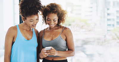 Buy stock photo Women, friends and happy with smartphone for fitness at gym on social media for exercise videos or tips. People, smile and communication with networking or mobile app for training instructions