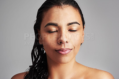Buy stock photo Woman, relax and natural beauty with skincare for hygiene or haircare on a gray studio background. Face of young female person or calm model with wet hair for shower, facial treatment or dermatology