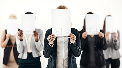 Buy stock photo Businesswoman, group and holding message on board in studio for anonymous recruitment of career. Professional, team and female people with blank paper hiding face for marketing as brand ambassador