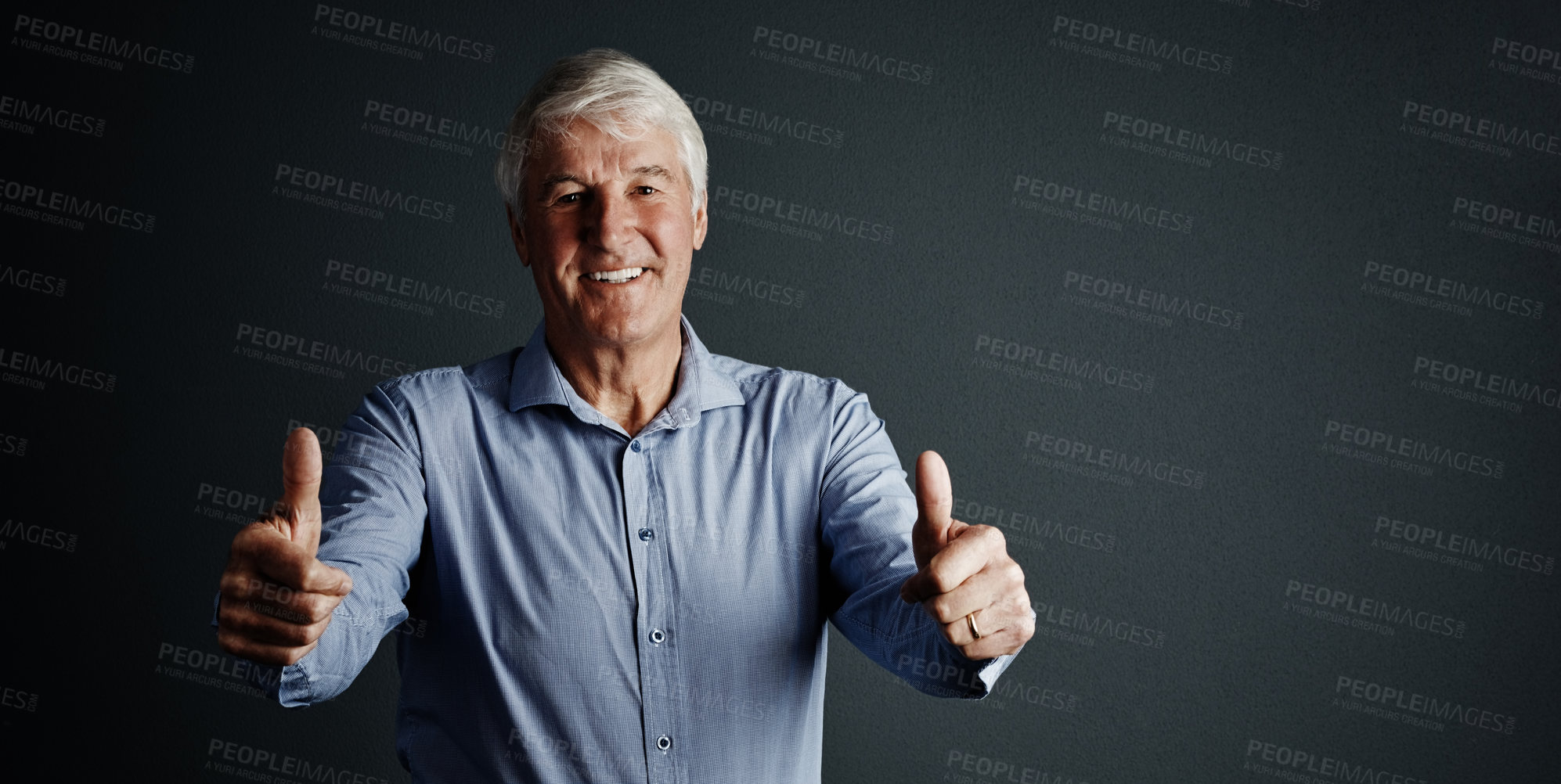 Buy stock photo Studio portrait of a handsome mature man giving you an approving thumbs up against a dark background