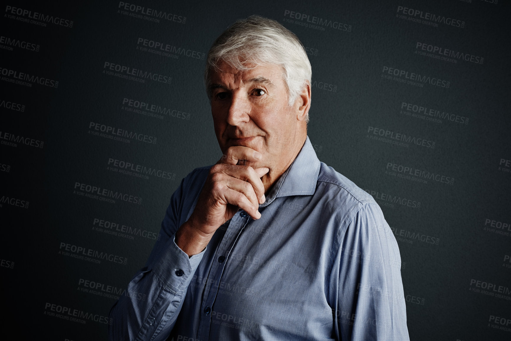 Buy stock photo Studio shot of a handsome mature man looking thoughtful against a dark background