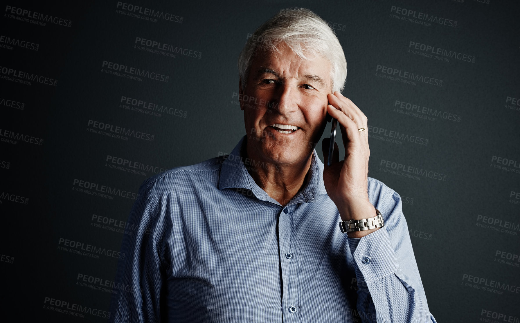 Buy stock photo Studio shot of a handsome mature man looking thoughtful while using his cellphone against a dark background