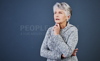 Buy stock photo Studio shot of a cheerful elderly woman standing and thinking while looking into the distance