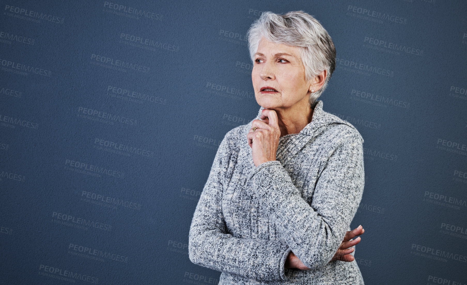 Buy stock photo Studio shot of a cheerful elderly woman standing and thinking while looking into the distance