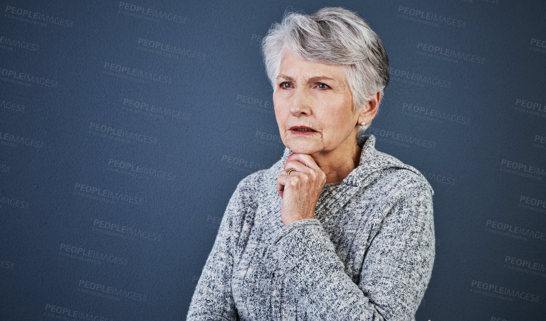 Buy stock photo Studio shot of a cheerful elderly woman standing and thinking while looking into the distance