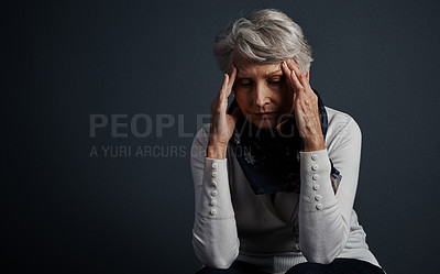 Buy stock photo Studio shot of a stressed out elderly woman sitting down with her eyes closed and contemplating