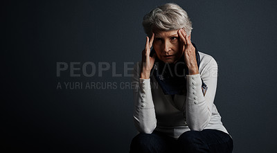 Buy stock photo Studio shot of a stressed out elderly woman sitting down with her eyes closed and contemplating