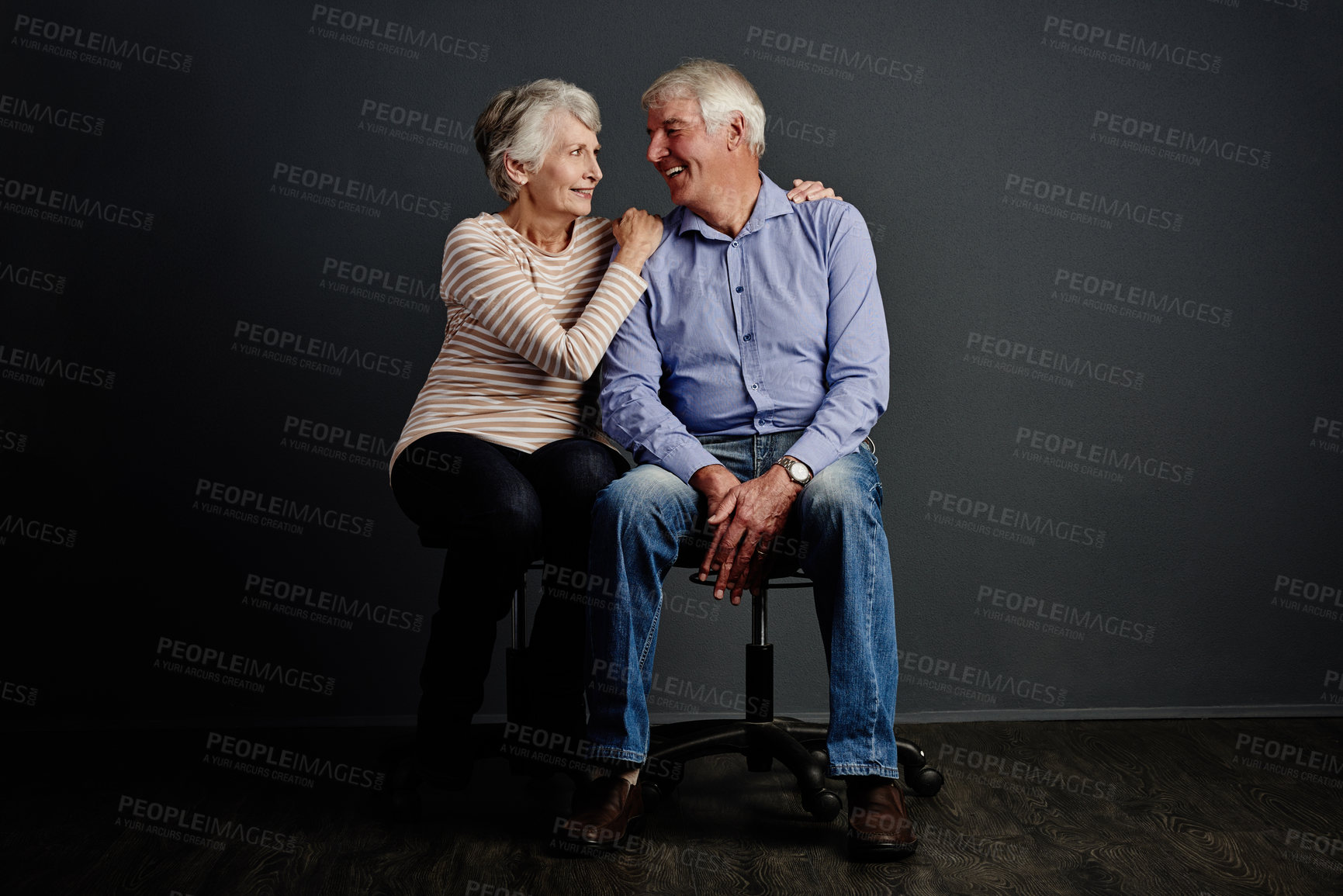 Buy stock photo Studio shot of an affectionate senior couple posing against a grey background