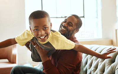 Buy stock photo Family, portrait and father with son on the the sofa for airplane, game and bonding in their home. Love, parent and child playing in living room, smile and relax while boy enjoy fly, fun and weekend