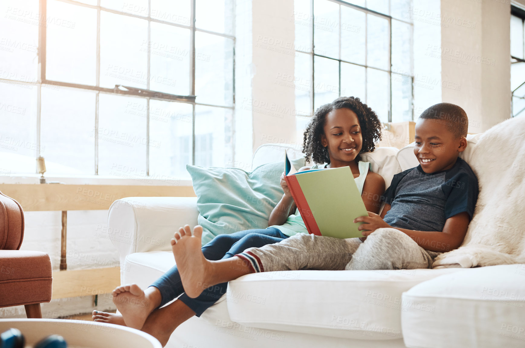 Buy stock photo Reading, children and book on sofa house for knowledge, bonding or learning literature, fantasy and language development. Boy, girl and storytelling, education and information of future growth

