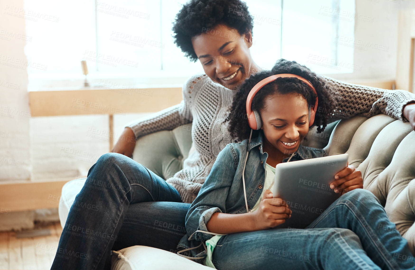 Buy stock photo Black family, headphones and tablet to listen to music, streaming and online learning on lounge sofa. Woman or mother and teenager together in living room while happy about home wifi for education