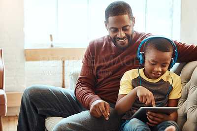 Buy stock photo Tablet, happy and dad with his son on a sofa watching a funny, comic or meme video on social media. Relax, smile and African man streaming a movie with child on mobile device while relaxing together.