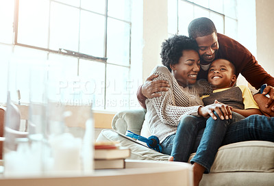 Buy stock photo Smile, relax and family hugging on a sofa together in the living room of their modern house. Happy, love and African mother and father bonding, embracing and resting with their boy child at home.