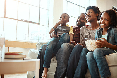 Buy stock photo Happy black family on sofa for movie, television or film together, bonding and quality time in living room. Popcorn, kids TV show and people, mother and father with kids, sitting on couch watching