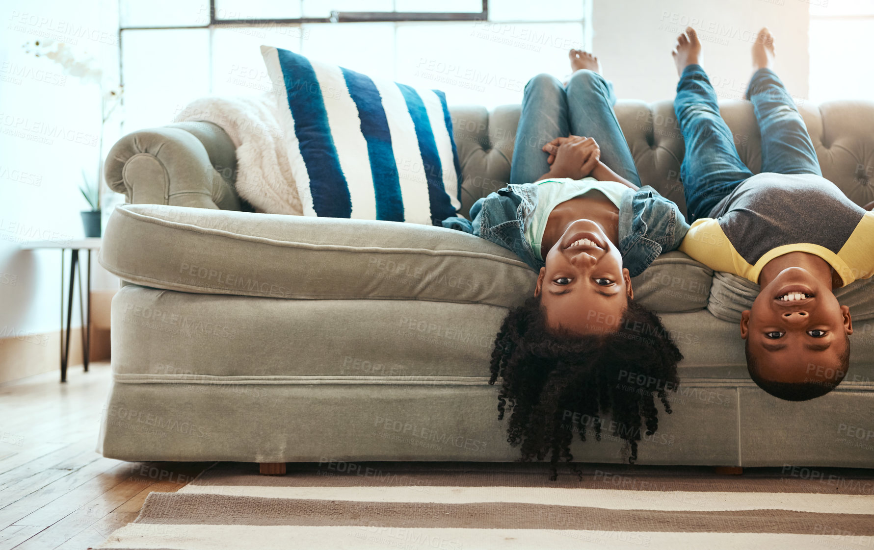 Buy stock photo Upside down, portrait and kids on couch, happiness and playing indoors weekend break, cheerful and siblings in living room. Children, home and boy with girl, fun or bonding together with smile or joy