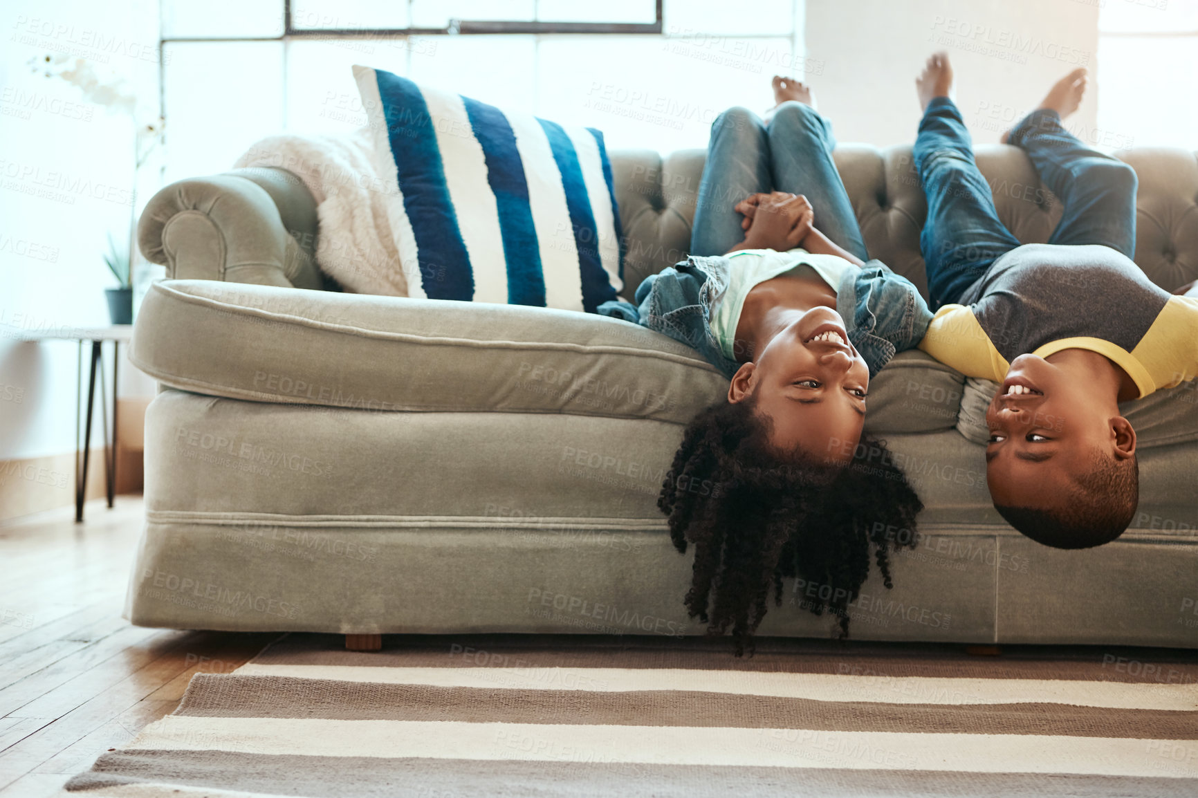 Buy stock photo Upside down, smile and kids on couch, happiness and playing indoors with siblings, weekend break and bonding together. Children, home and boy with girl, cheerful and excited in living room with joy