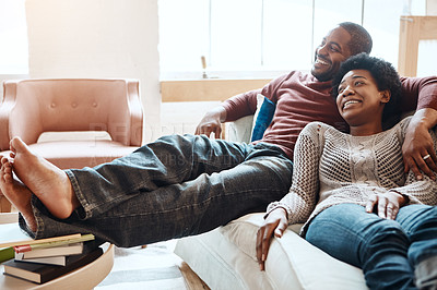 Buy stock photo Couple, relax and watching tv on a sofa, happy and smile while bonding in their home together. Television, resting and black woman with man on a sofa, resting and having fun in the living room  