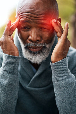 Buy stock photo Shot of a senior man experiencing a headache outside 