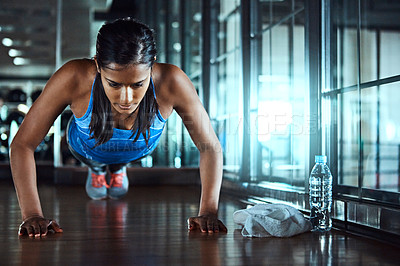 Buy stock photo Fitness, push up and woman athlete in gym for workout with strength, wellness and arms training. Serious, health and female person with exercise for body goals for muscles and power in sports center.