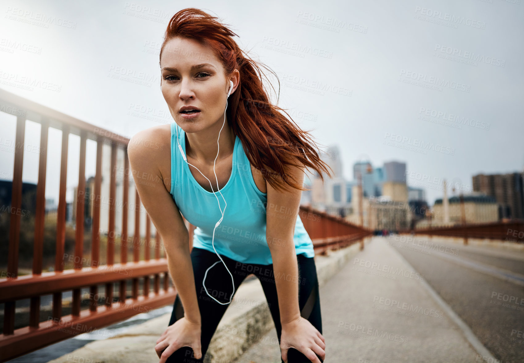 Buy stock photo Portrait of a sporty young woman taking a break while running in the city