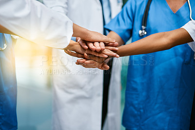Buy stock photo Shot of a group of unrecognisable medical practitioners joining their hands together in unity