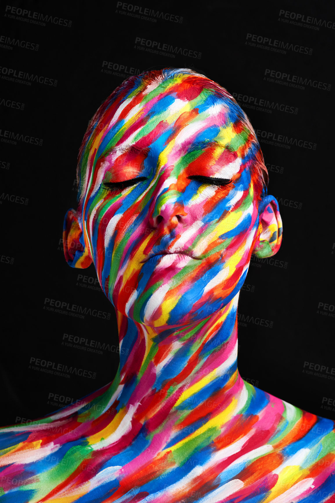 Buy stock photo Studio shot of a young woman posing with brightly colored paint on her face against a black background