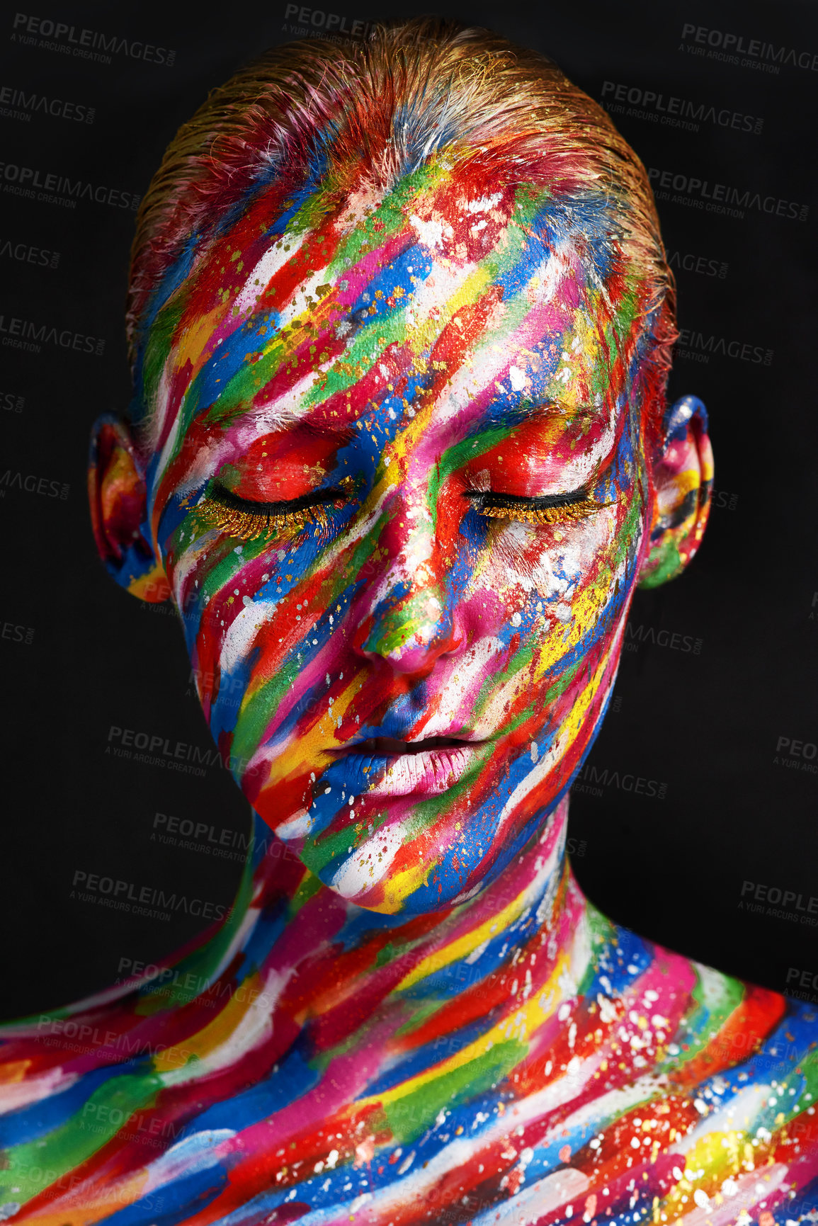 Buy stock photo Studio shot of a young woman posing with brightly colored paint on her face against a black background