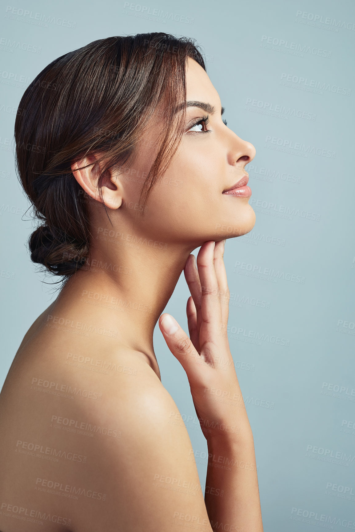 Buy stock photo Sideview of a young woman with flawless skin against a grey background