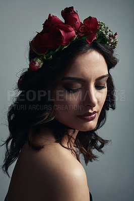 Buy stock photo Studio shot of a beautiful young woman wearing a floral head wreath against a grey background