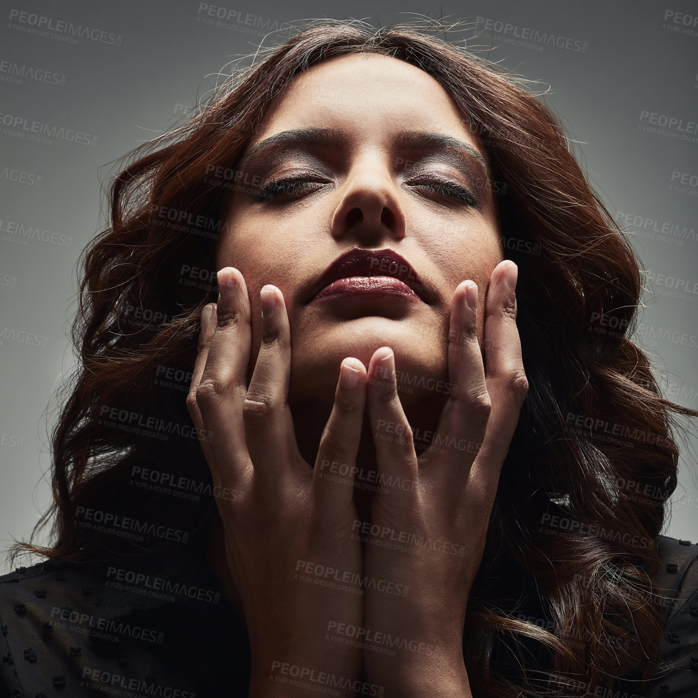 Buy stock photo Studio shot of a beautiful young woman posing against a grey background